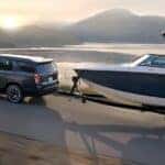 A gray 2021 Chevy Tahoe towing a boat.