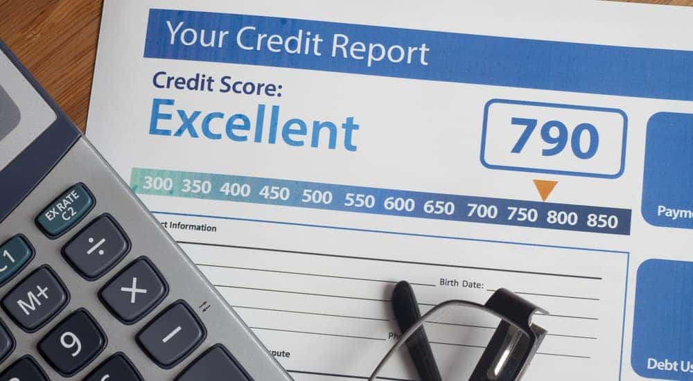 A credit report is shown on a table at a buy here pay here dealership.
