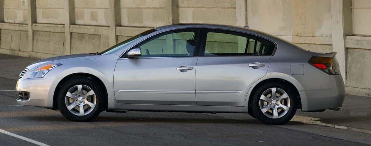 A silver 2009 used Nissan Altima is shown in a parking garage.