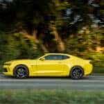 A yellow 2016 Chevy Camaro from the side.