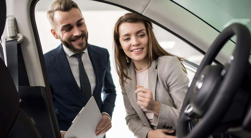 A salesperson is shown talking to someone about their trade in value.