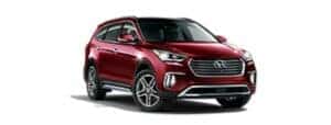 A red 2017 Hyundai Santa Fe is angled right.