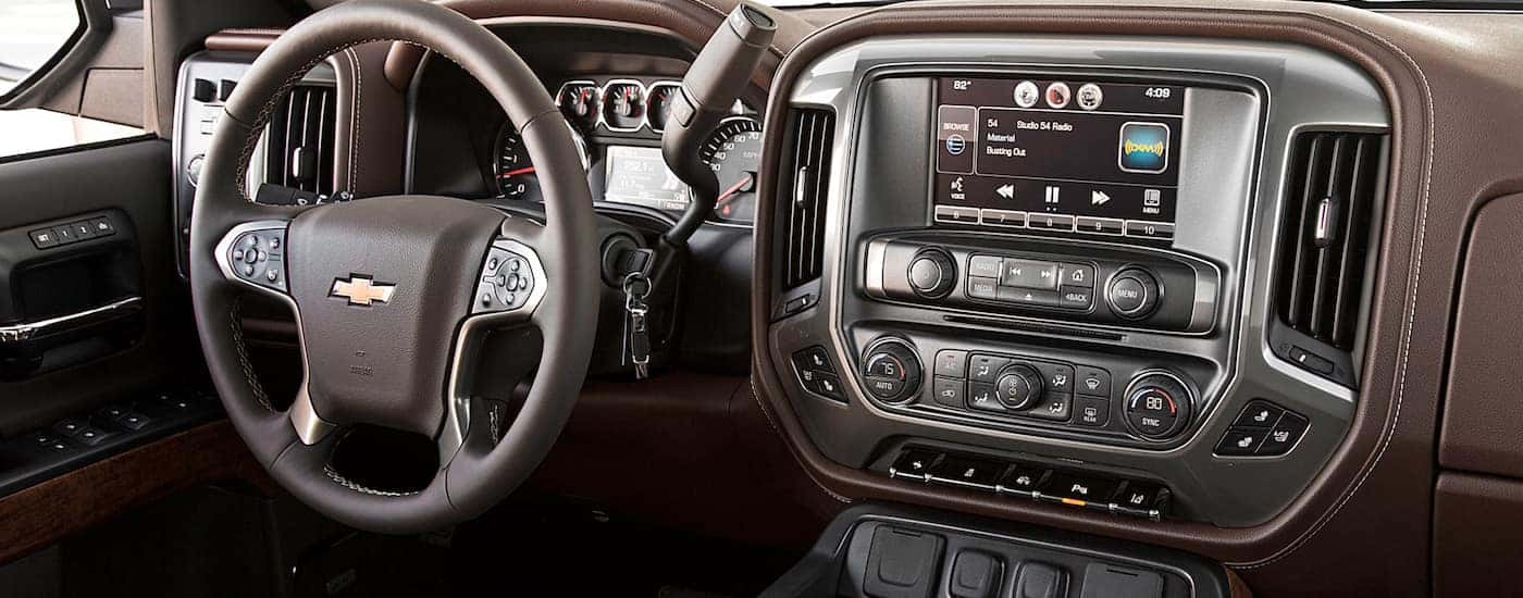 A view at the front dashboard of the 2018 Silverado with a touchscreen, climate control, and other exciting tech,