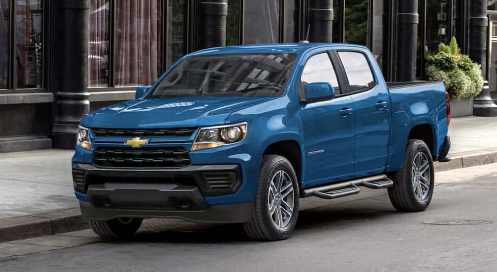 A blue 2022 Chevy Colorado parked on a city street.