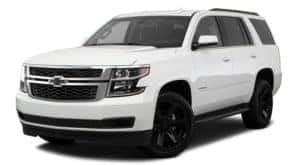 A white 2018 Chevy Tahoe is parked and facing left.