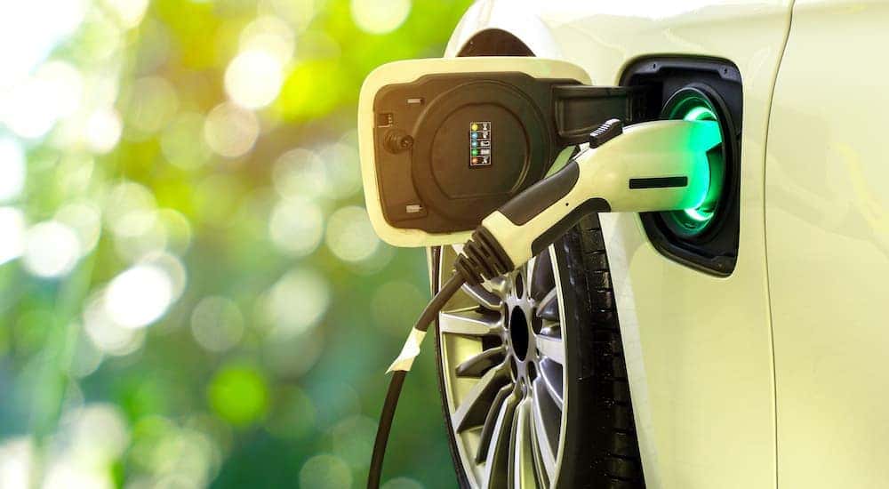 An electric vehicle is shown charging.