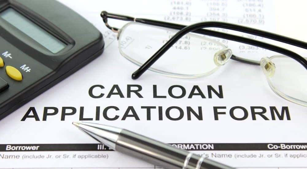 A paper car loan application is shown at a Buy Here Pay Here in Lexington.