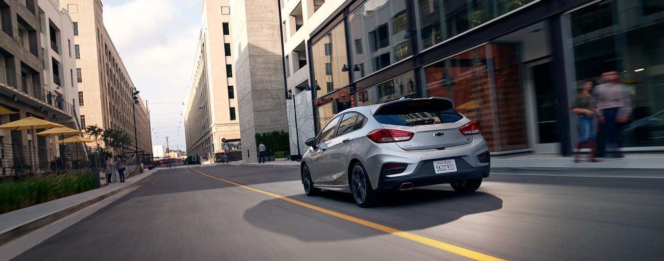 Silver 2019 Chevy Cruze hatchback driving on city street