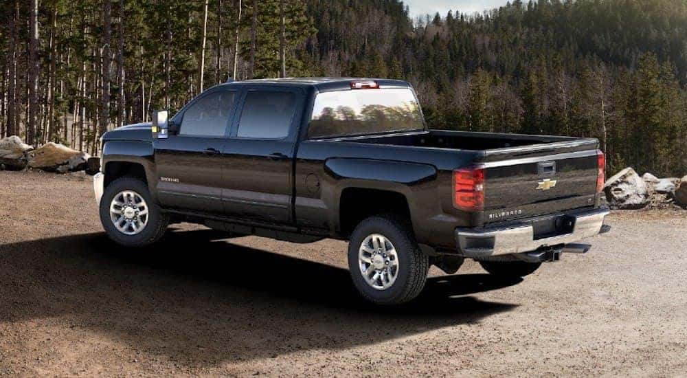 A black 2018 Chevy Silverado 3500HD in the forest