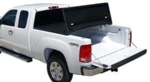 A white Chevy Silverado with a tri-fold tonneau cover on the bed