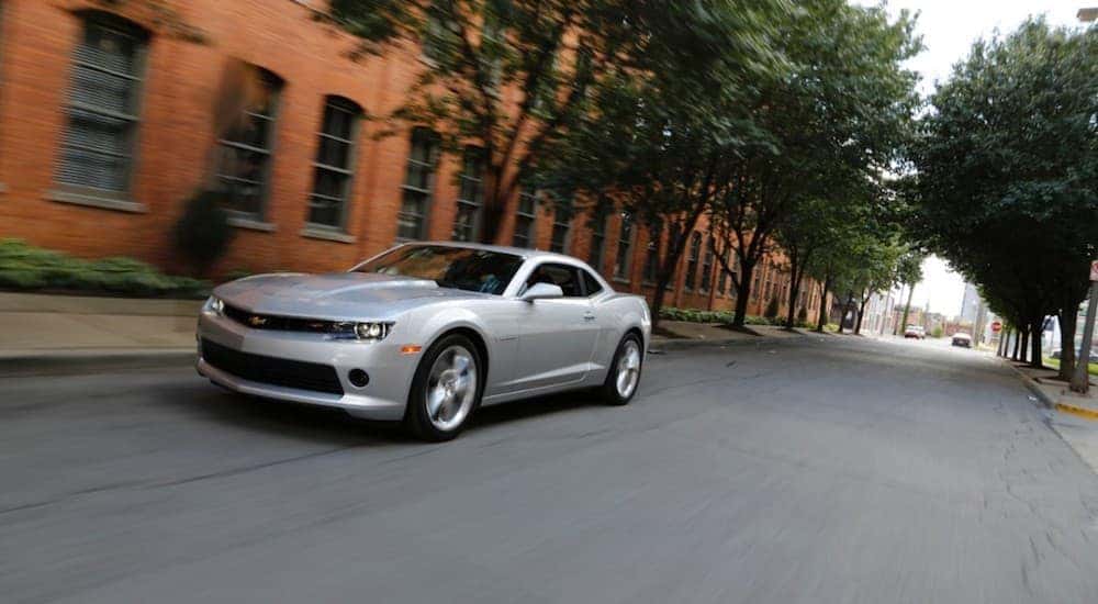 A silver 2014 Chevy Camaro on a city street