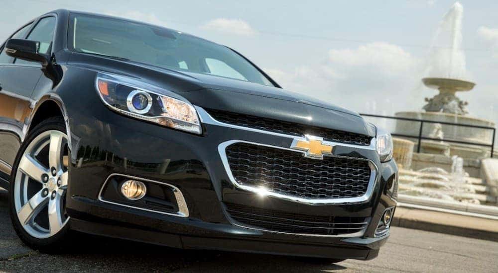 A black 2014 Chevy Malibu in a park