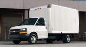 A white 2019 Chevy Cutaway box truck is parked outside a loading dock in Cincinnati, OH.