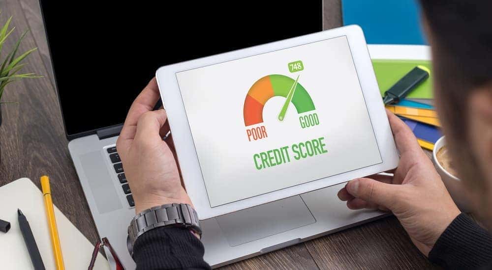 A customer sees improvement in their credit score after paying on time with a buy here pay here loan near Louisville.