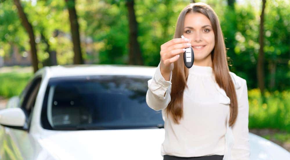 A woman happy with her new car from a Buy Here Pay Here in Louisville is shown.