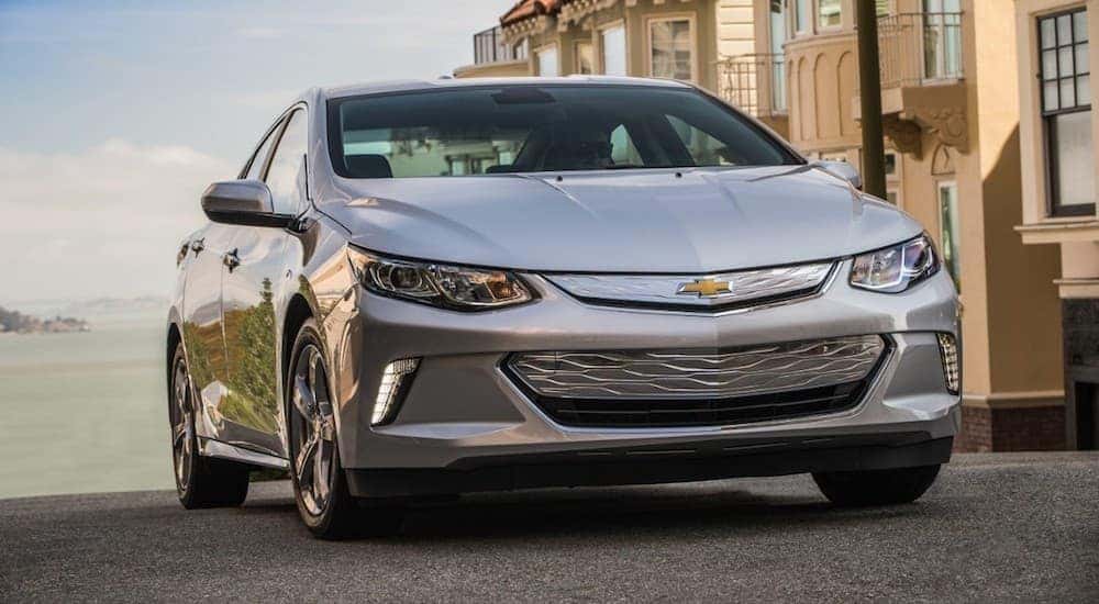 A silver used 2016 Chevy Volt at a beach side building