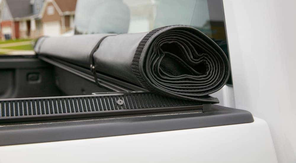 A roll-up Chevy Tonneau Cover on a white Silverado