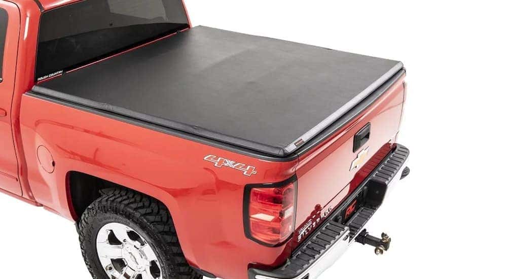 A black tonneau cover on a red Chevy Silverado