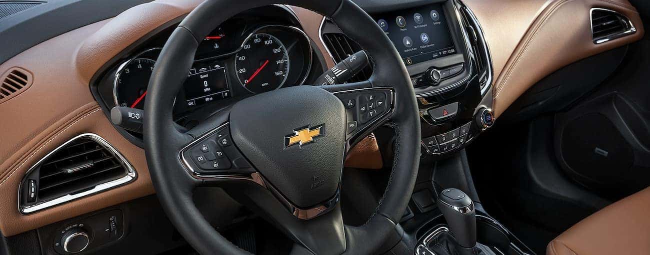 A closeup of the steering wheel and interior of a 2019 Chevy Cruze