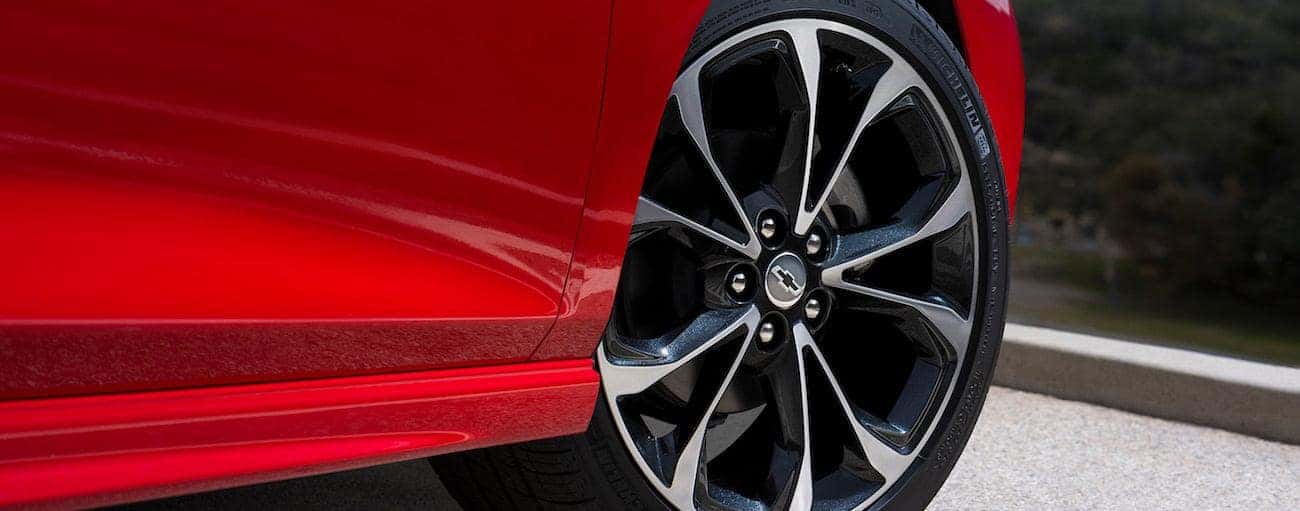 A closeup of the wheel on a red 2019 Chevy Cruze hatchback