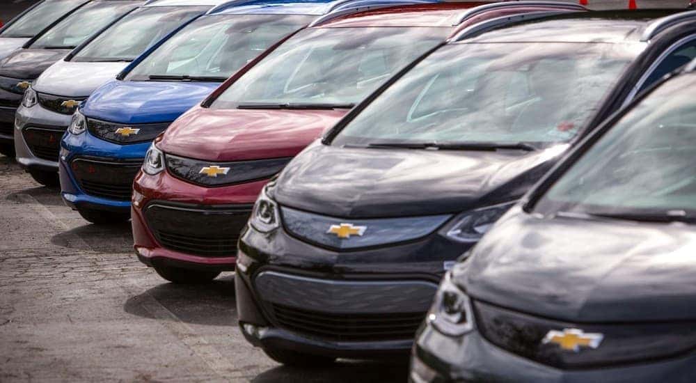The front ends of a line of 2017 Chevy Bolts are shown in multiple colors. When looking for used cars, Dayton, Ohio has great options.