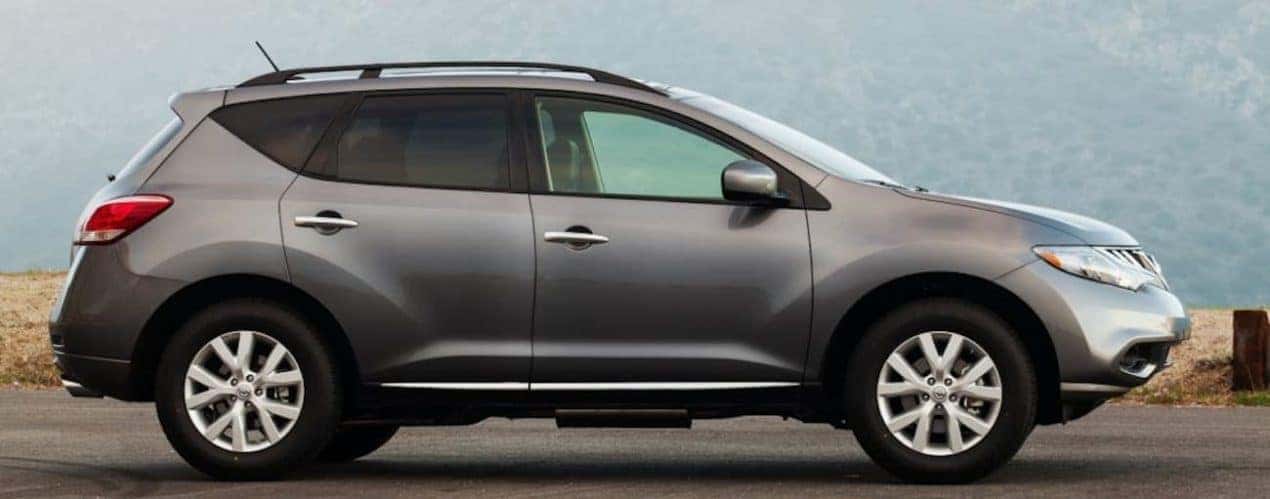A grey 2014 used Nissan Murano is shown from the side.