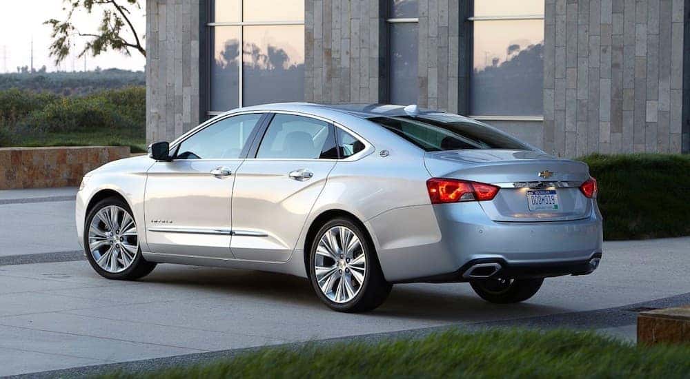 A silver 2018 Chevy Impala LTZ is parked outside a modern house near Cincinnati, OH.