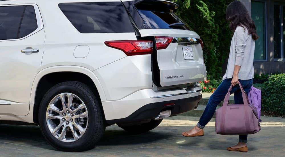 A woman is using the tailgate lift to load her white 2019 Chevy Traverse at her home near Dayton, OH.
