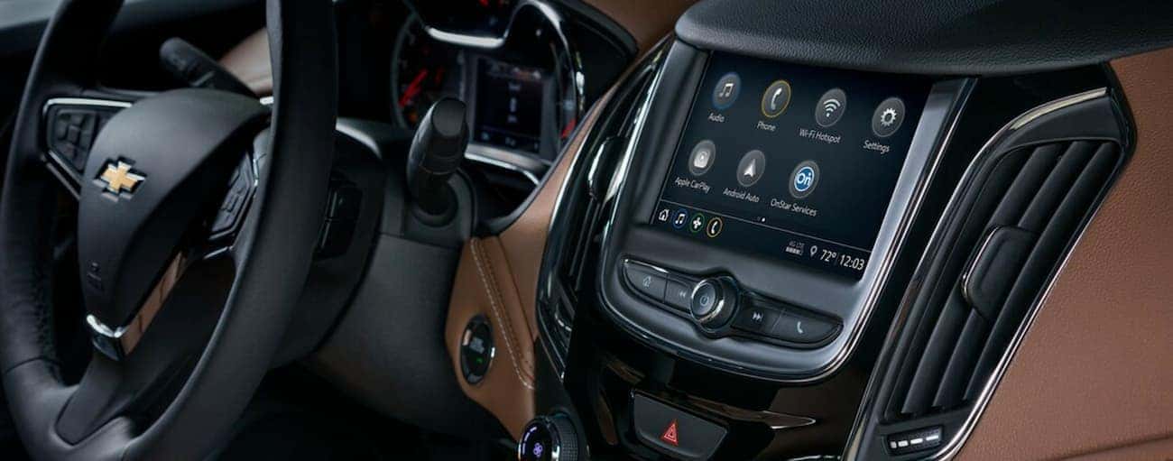 The brown and black interior of the 2019 Chevy Cruze is shown featuring the entertainment features, which win when comparing the 2019 Chevy Cruze vs 2019 Hyundai Elantra in Cincinnati, OH.
