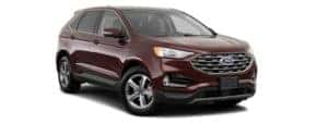 A burgundy 2019 Ford Edge is facing right.
