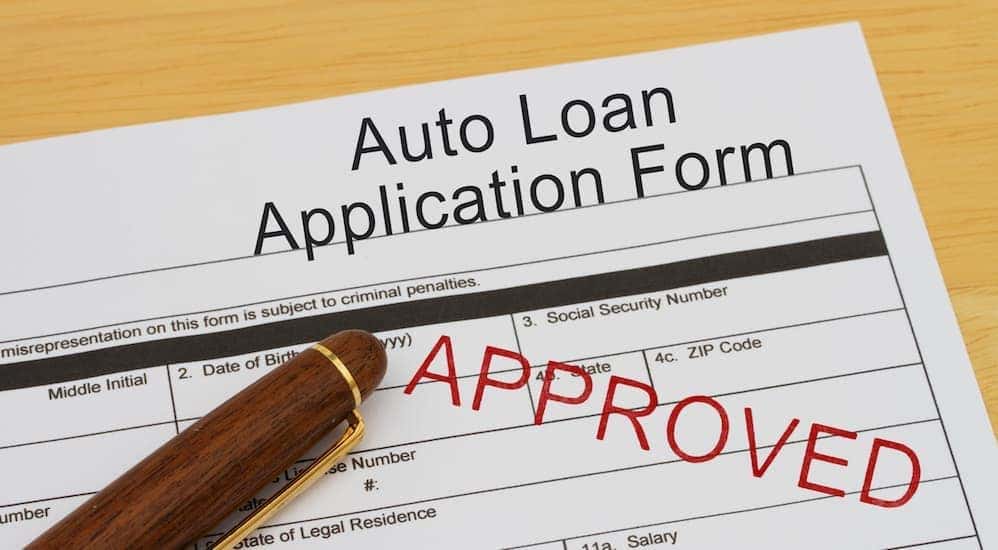A car loan application is shown at a buy here pay here Louisville dealership.
