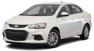 A white 2017 Chevy Sonic is parked and facing left.