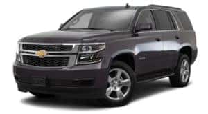 A black 2017 Chevy Tahoe is parked and facing left.