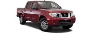 A red 2017 Nissan Frontier is facing right.