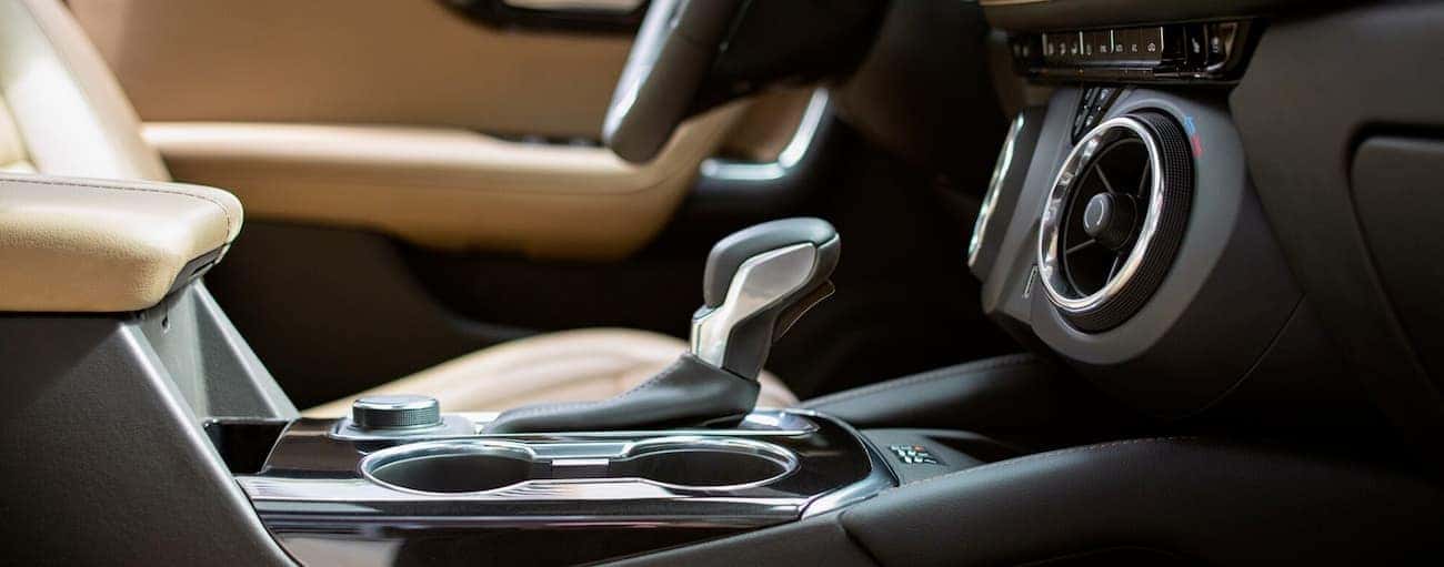 The black and tan interior of the 2019 Chevy Blazer is shown with a closeup of the shifter.