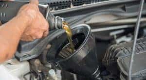 Oil is being poured into a funnel during a quick lube in Cincinnati, OH.
