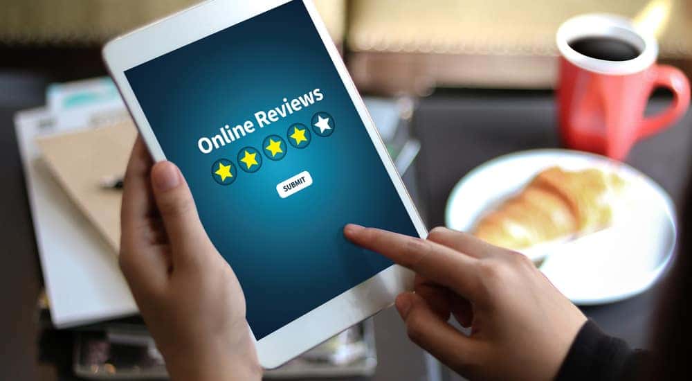 A woman is looking up customer reviews on local mechanics in Cincinnati, OH.
