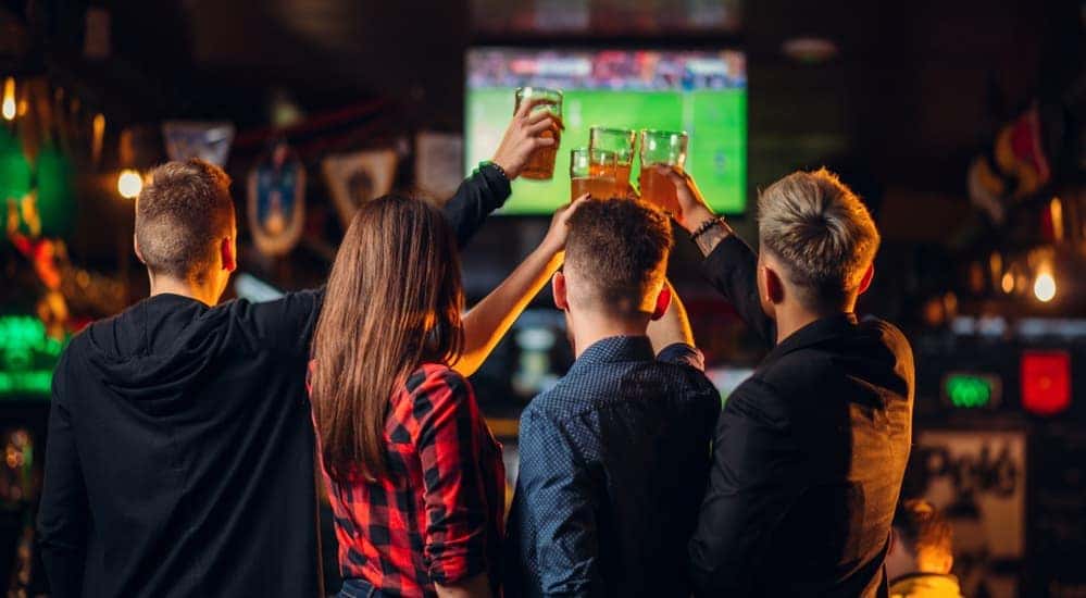 A group of friends are at a local bar in Dayton, Ohio watching a football game.