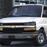 A silver 2020 Chevy Commercial van is parked in front of a building near Cincinnati, OH.
