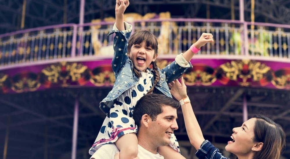 A smiling family is enjoying a fun activity in Dayton, Ohio.