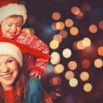 A mother has her son on her shoulders while they enjoy winter events in Columbus, OH.