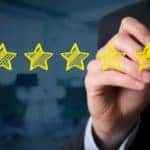 Five stars are being written on a clear board with a yellow marker.