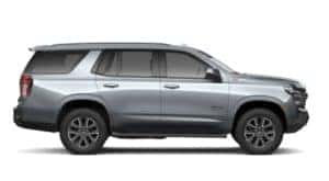 A silver 2021 Chevy Tahoe is facing right.