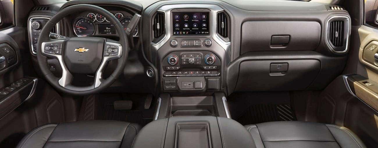 The black dashboard and infotainment features of a 2020 Chevy Silverado are shown.