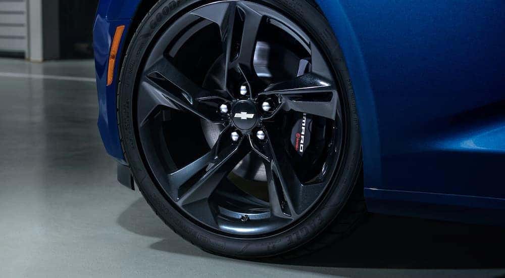 The wheel setup on a blue 2020 Chevy Camaro is shown in closeup.