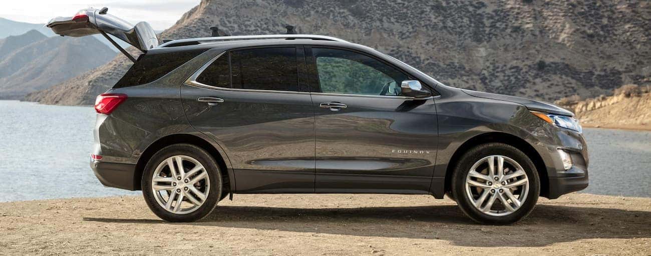 The liftgate is open on a grey 2020 Chevy Equinox at a lake.
