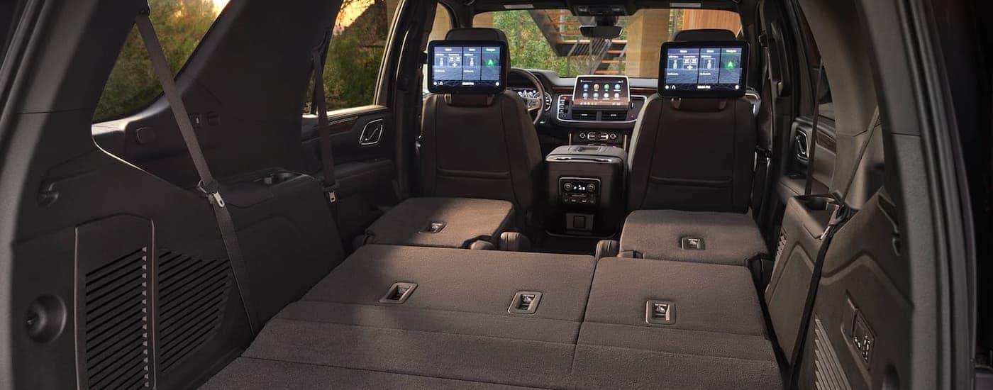 The cargo area of a 2021 Chevy Tahoe is shown with the back two rows of seats down.