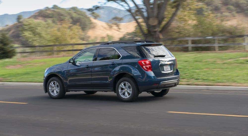 A blue 2016 Chevy Equinox is driving on a street outside Cincinnati, OH.