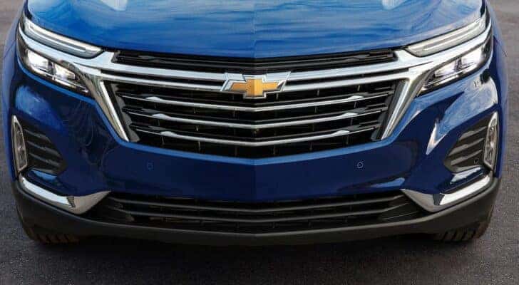 A close up of the grille on a blue 2022 Chevy Equinox is shown.