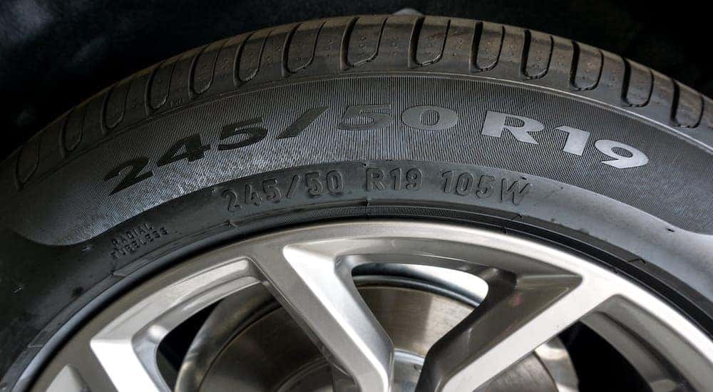 The side of a tire, including the tire code, is shown.